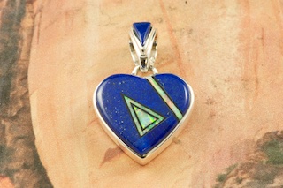 Genuine Blue Lapis and Black Jade inlaid in Sterling Silver. Beautiful Heart Pendant with Fire and Ice Lab Opal Accents.  Free 18" Sterling Silver Chain with purchase of pendant. Designed by Navajo Artist Calvin Begay. Signed.